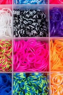 A set of multi-colored elastic bands for weaving bracelets for children. Stock Photos