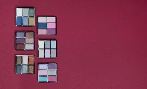 A set of multi-colored eyeshadow on a pink background, copy space for text 스톡 사진