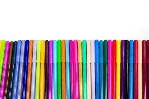 A set of multi-colored felt-tip pens in a row, rainbow on a light white banne Stock Photos