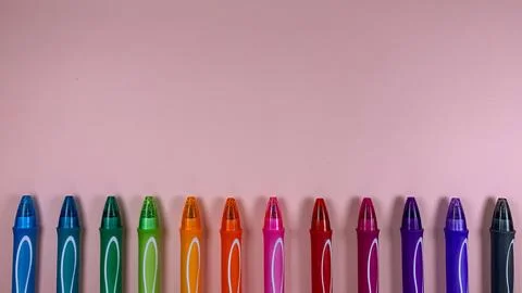 Set of multi-colored gel pens on a pink background Stock Photos
