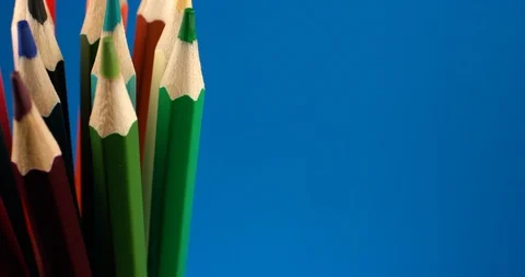 Set of multi-colored pencils rotating on a blue screen, chromakey background Stock Footage 107909085