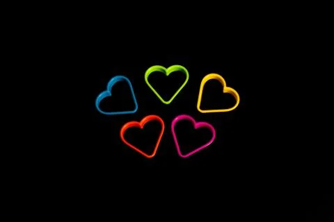 A set of multi-colored plastic molds for making cookies in the form of a hear Stock Photos