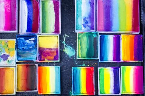Set of multi-colored professional paints for drawing on face. Stock Photos