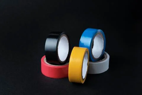 Set of multi colored rolled adhesive tape at black background Stock Photos