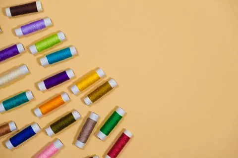 A set of multi-colored threads for sewing with an empty space for text on a Stock Photos