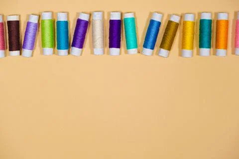 A set of multi-colored threads for sewing with an empty space for text on a Stock Photos
