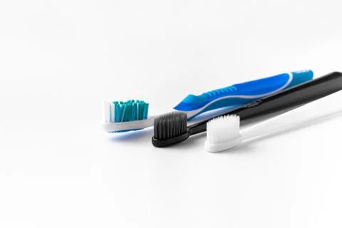 A set of multi-colored toothbrushes on a white background. Place to write the Stock Photos