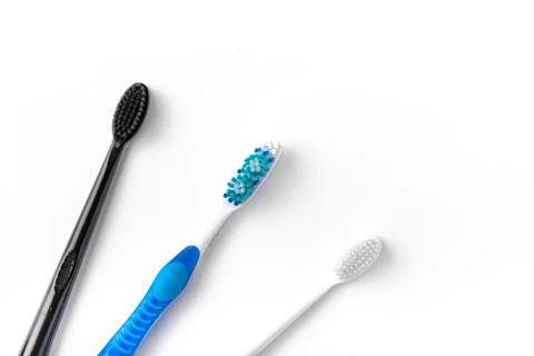 A set of multi-colored toothbrushes on a white background. Place to write the Stock Photos