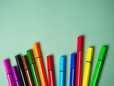 A set of multicolor felt-tip pens, multi-colored felt-tip pens on a green bac Stock Photos