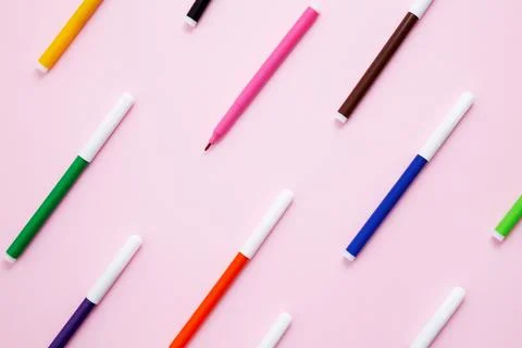 Set of multicolored felt-tip pens on pink background. Back to school. Flat la Stock Photos