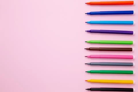Set of multicolored felt-tip pens on pink background. Back to school. Flat la Stock Photos