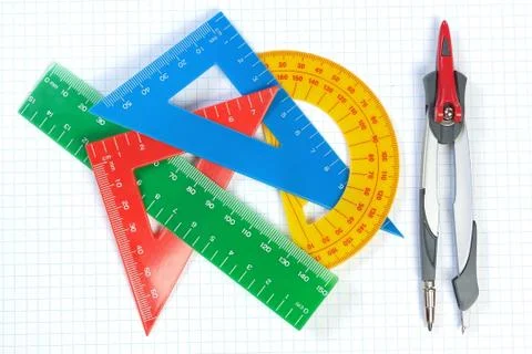 Set of multicolored lines of triangles, protractors and Caliper. On a white b Stock Photos