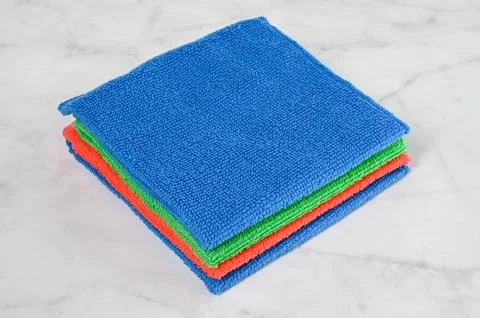 Set multicolored microfiber cloths light marble background. Stock Photos