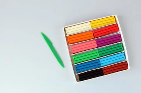 Set of multicolored modeling clay on blue surface Stock Photos