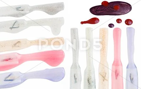 Set of multicolored nail polish brushes and drops isolated on white Stock Photos
