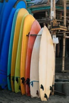 Set of multicolored surf boards in a stack by ocean.Bali.Indonesia. Surf boards Stock Photos