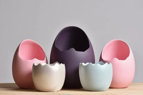 Set of multicolored vases in the form of an eggshell on a gray background for Stock Photos