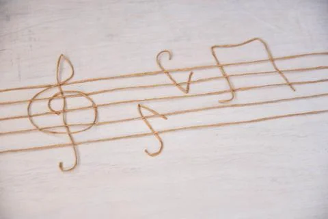 Set of musical notes isolated on white wooden background. Stock Photos