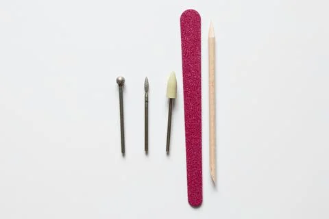 A set of nail drill bits: a ball, a cone, a silicone polisher, and a file o.. Stock Photos