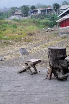 A set of natural tree trunk table and traditional wooden chairs in a rural Stock Photos
