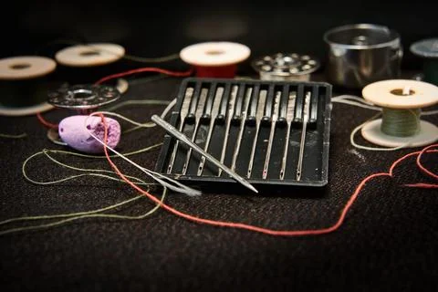 Set of needles and threads for a sewing machine. Stock Photos