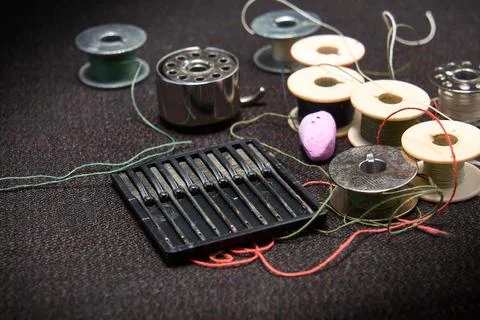 Set of needles and threads for a sewing machine. Stock Photos