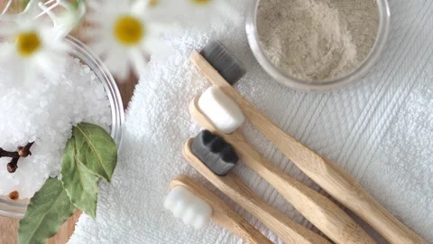 A set of new bamboo toothbrushes with soft bristles on a white terry towel. Toot Stock Footage 247204310