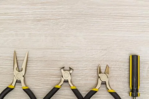 Set of new tools for the master of various applications on light wooden backg Stock Photos