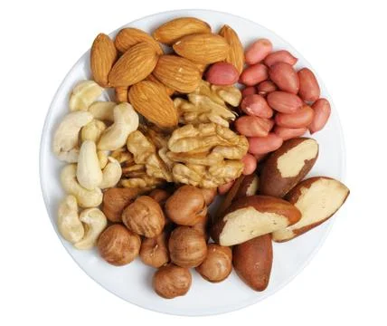 Set of nuts on a white plate, isolation Stock Photos