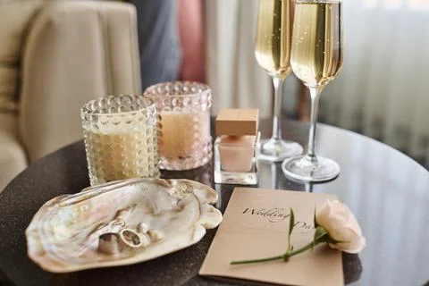 Set of objects creating romantic composition on small round table Stock Photos
