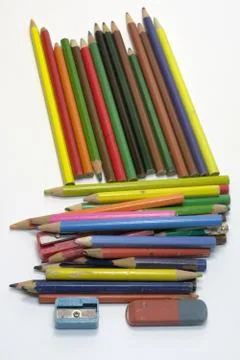 Set of old colored pencils, two sharpeners and bilateral eraser Stock Photos