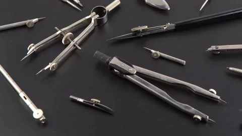 Set of old different compasses. Retro metal compasses and drafting tools on a Stock Footage 234972952