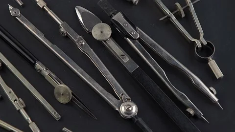 Set of old different compasses. Retro metal compasses and drafting tools on a Stock Footage 234973186