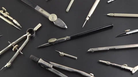 Set of old different compasses. Retro metal compasses and drafting tools on a Stock Footage 235550502