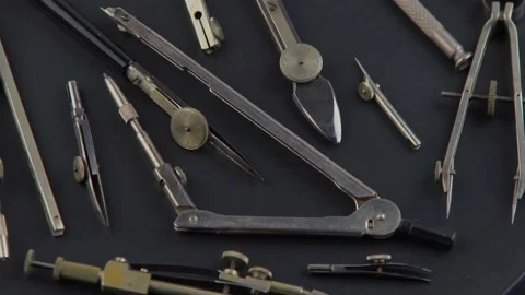 Set of old different compasses. Retro metal compasses and drafting tools on a Stock Footage 236244295