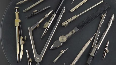 Set of old different compasses. Retro metal compasses and drafting tools on a Stock Footage 236778381