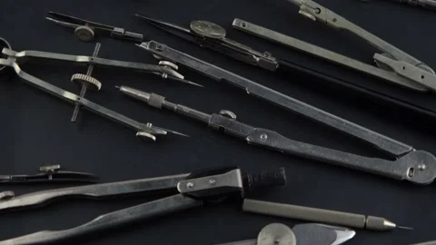 Set of old different compasses. Retro metal compasses and drafting tools on a Stock Footage 237332906