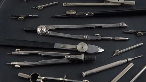 Set of old different compasses. Retro metal compasses and drafting tools on a Stock Footage 238628751