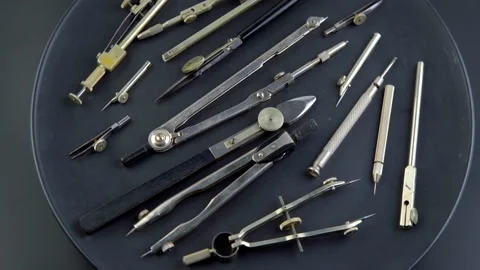 Set of old different compasses. Retro metal compasses and drafting tools on a Stock Footage 239178668