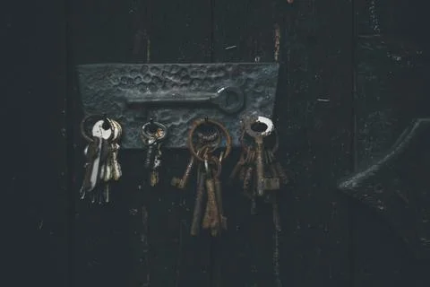 Set of old keys hanging on the wall Stock Photos