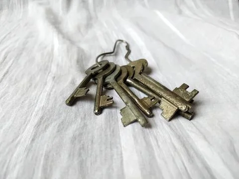 Set of old metal keys on light wooden surface Stock Photos