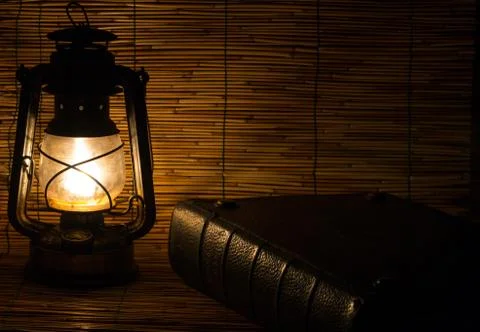 Set with an old rusty lantern and a book Stock Photos