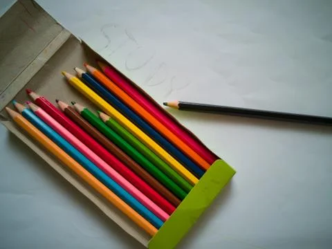Set of old used and broken colour crayons on old paper Foto stock