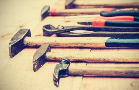 Set of old vintage hand construction tools on a wooden background, well used  Stock Photos