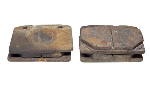 Set of old worn and rusty brake pads, dismantled from car. isolated on whit.. Stock Photos