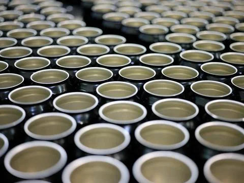Set of open beer cans in a packaging factory Stock Photos