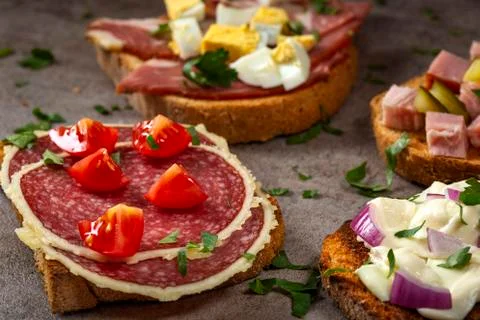 Set of open sandwiches with boiled eggs, cucumbers, salami, cheese and smoked Stock Photos