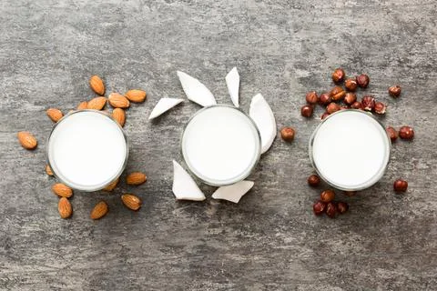 Set or collection of various vegan milk almond, coconut, cashew, on table bac Stock Photos