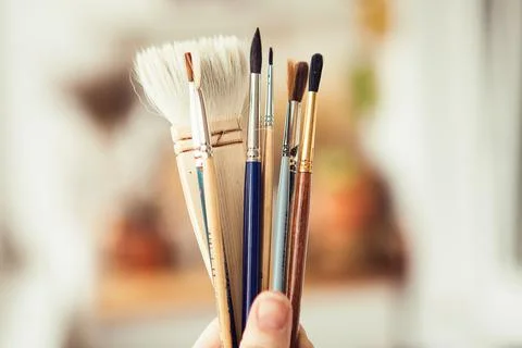 Set with paint brushes. Different paint brushes in somebody's hand Stock Photos