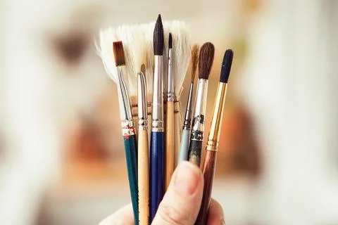 Set with paint brushes. Different paint brushes in somebody's hand Stock Photos